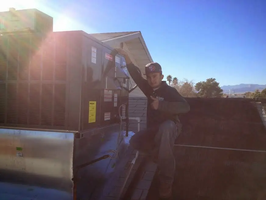 HVAC technician performing HVAC Inspection on a rooftop unit in Williston